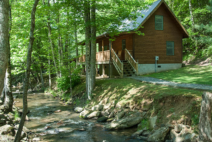 log cabin in the woods stream